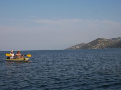Туристы плывут на каноэ по Скадарскому озеру